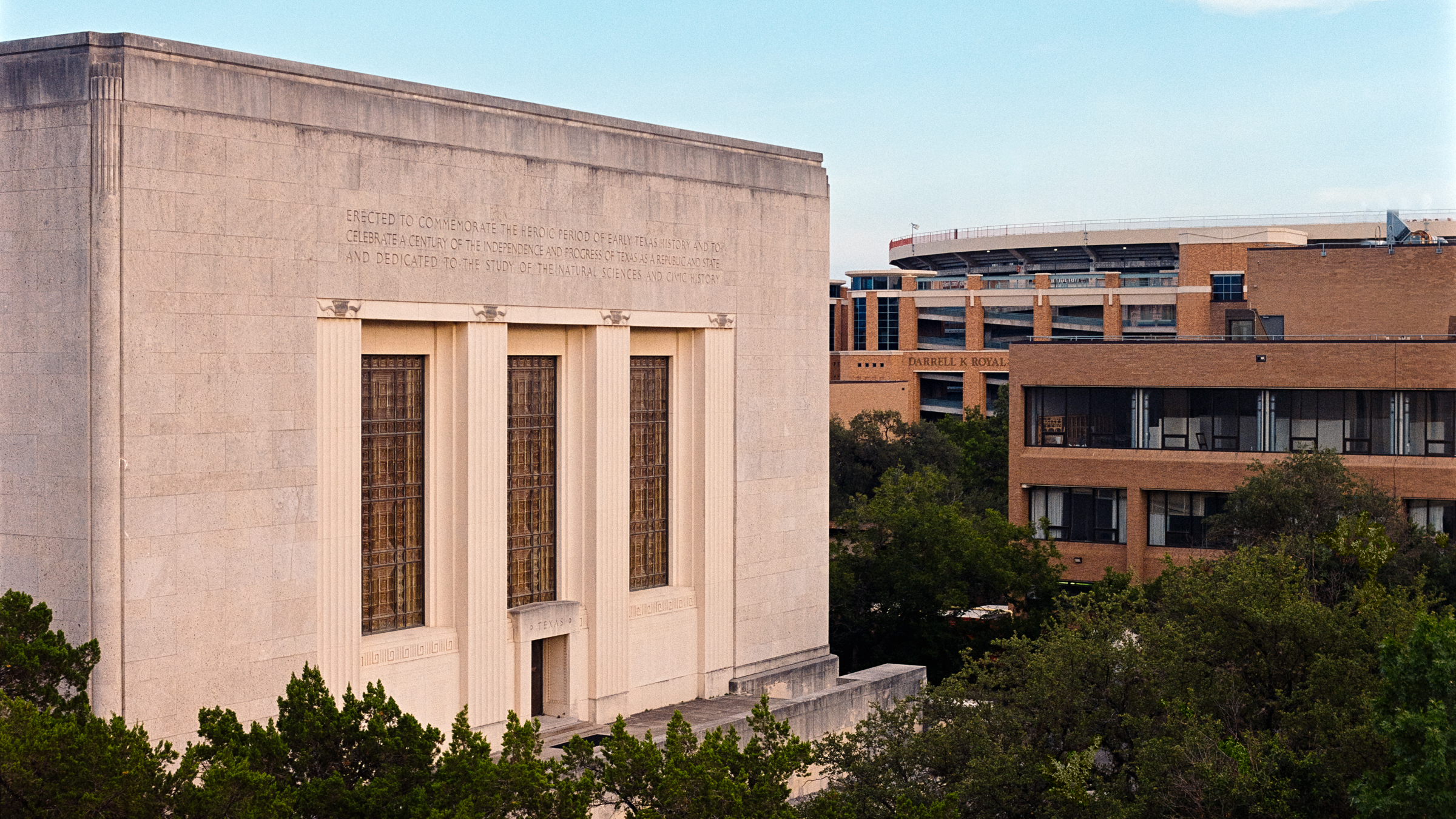 Photo of a limestone building facade with three tall arched windows. The Texas Memorial Museum. Texas Museum of Science and Natural History. 