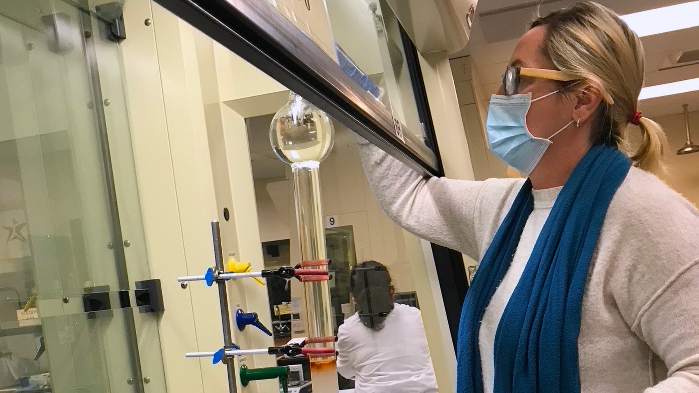 Shawn Amorde sets up a separations column which is used to purify chemicals after a reaction. Photo credit: Jackie Stamatedes