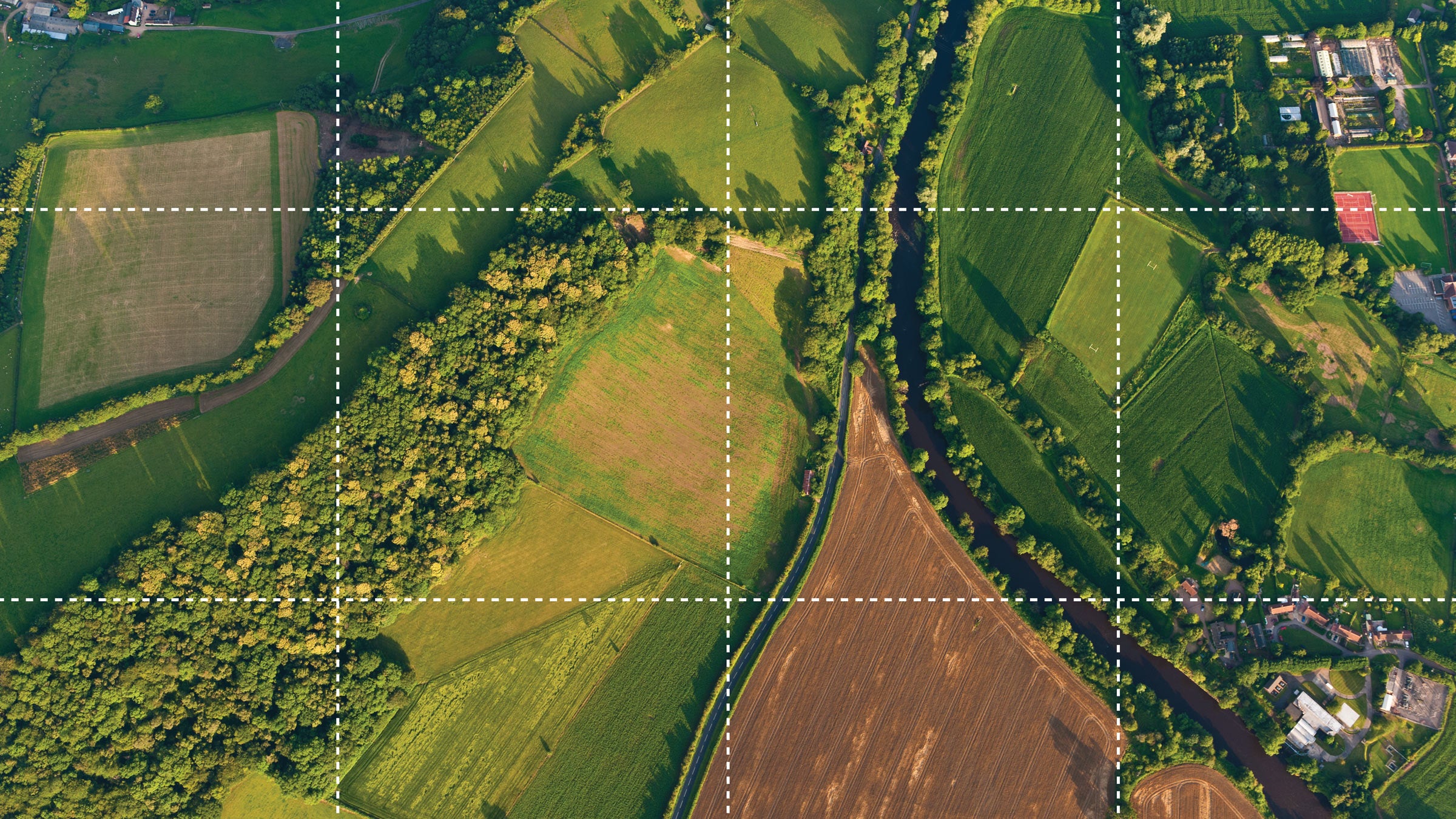 Aerial image showing different types of land use, including farming, forest and housing.