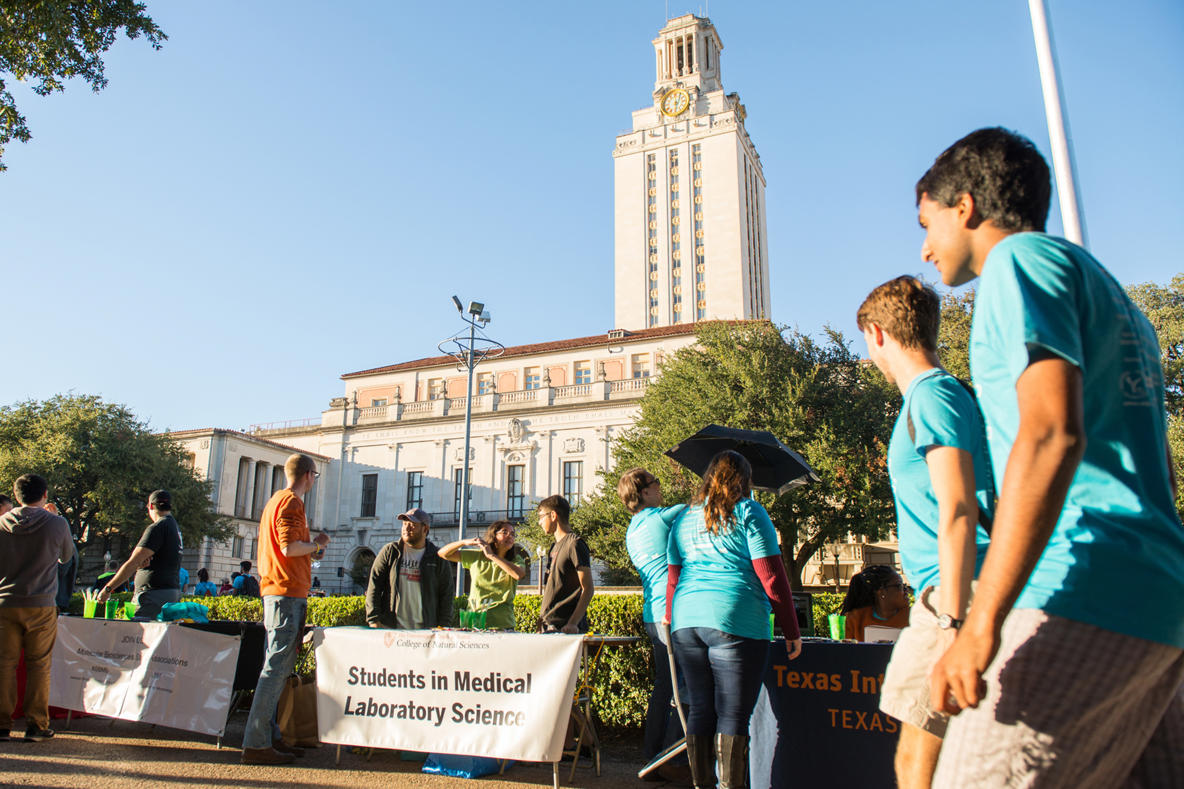 Photo of science students tabling on the main mall with the UT Tower in the background.