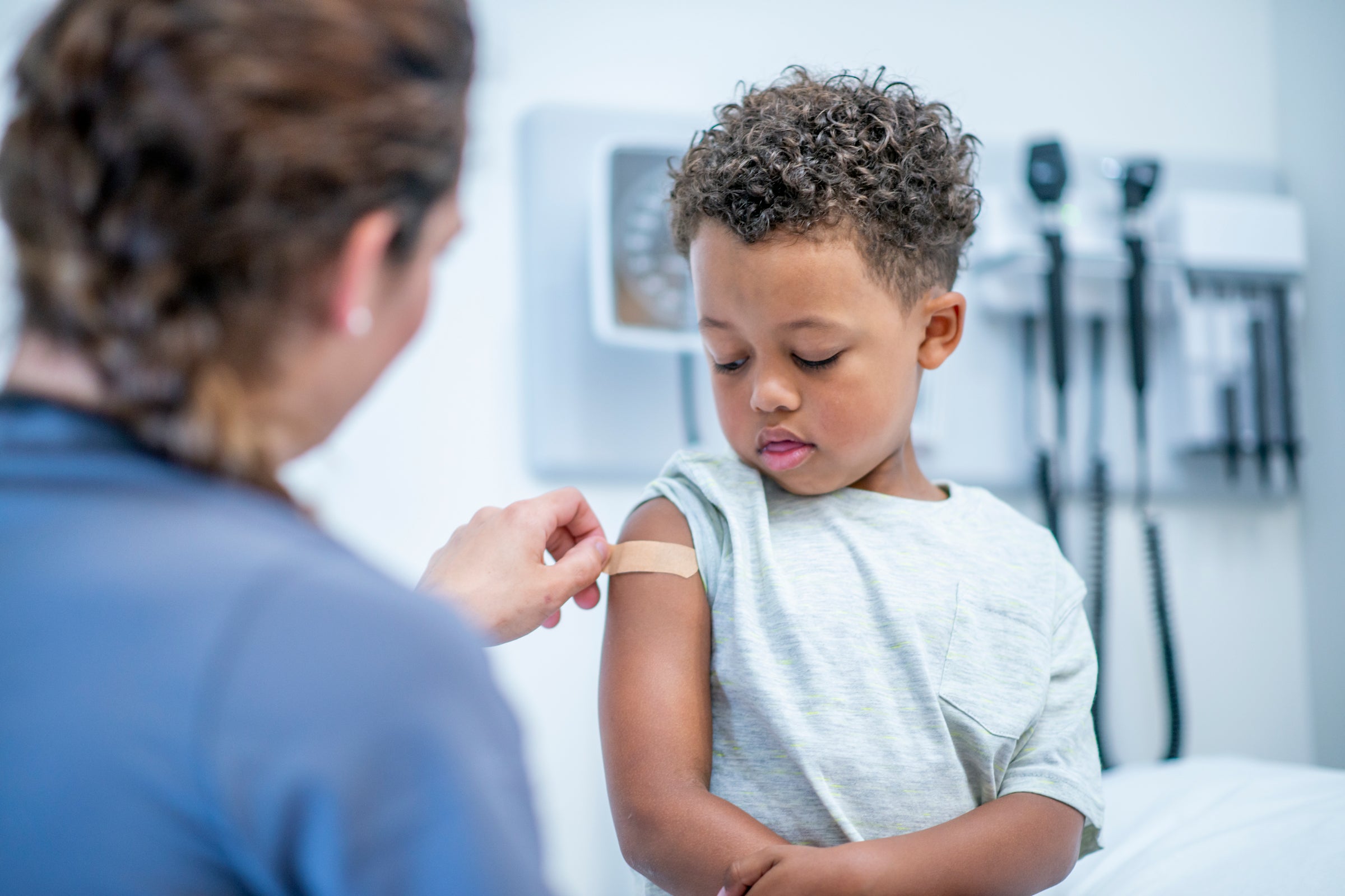 A child gets a bandage after receiving a vaccination