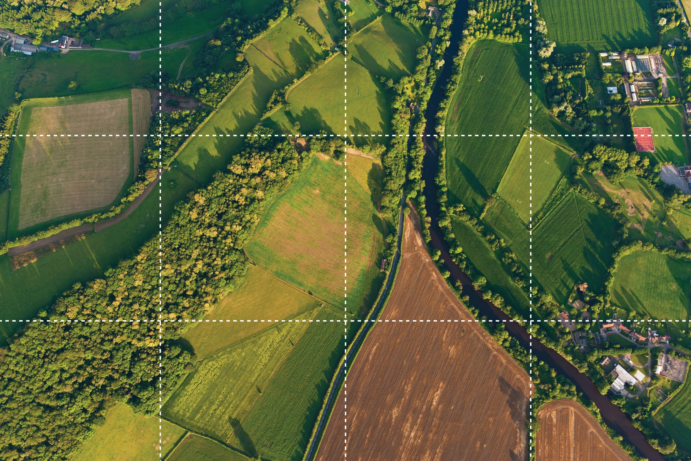 Aerial image showing different types of land use, including farming, forest and housing.