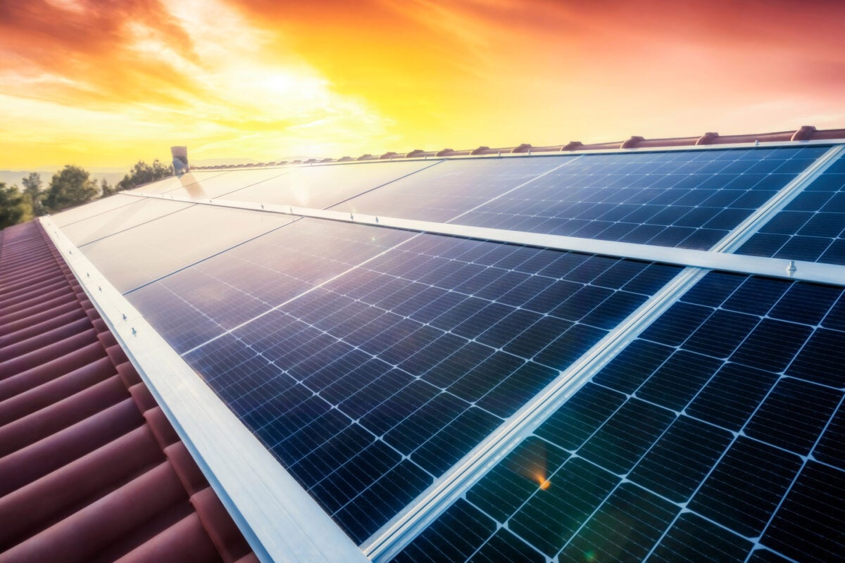 A solar panel array with bright sunlight shining on it