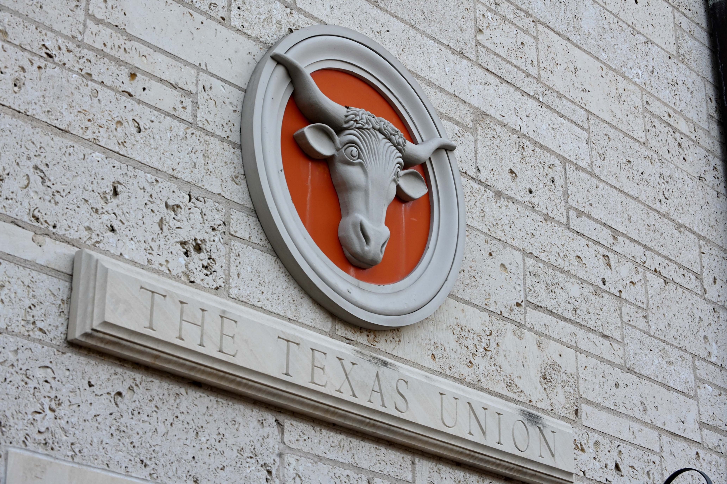An image of a Texas Longhorn appears in a circle on a limestone wall above the words The Texas Union