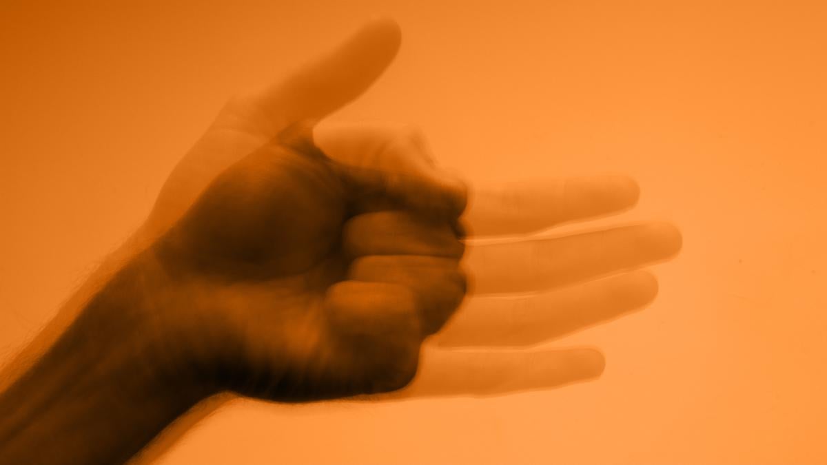 A fist is superimposed on the ghostly outline of an open palm.