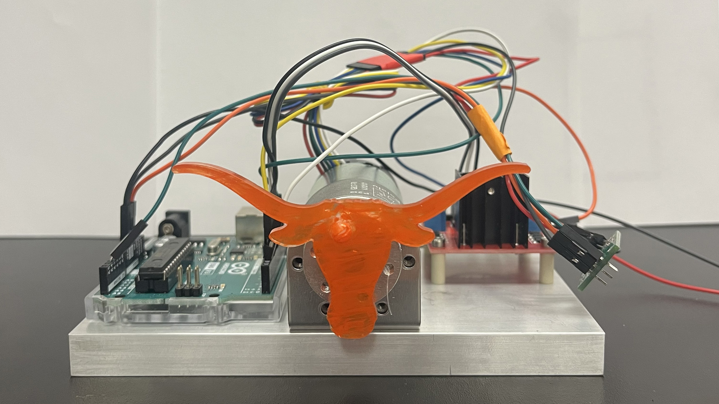 A motor with an orange longhorn logo 