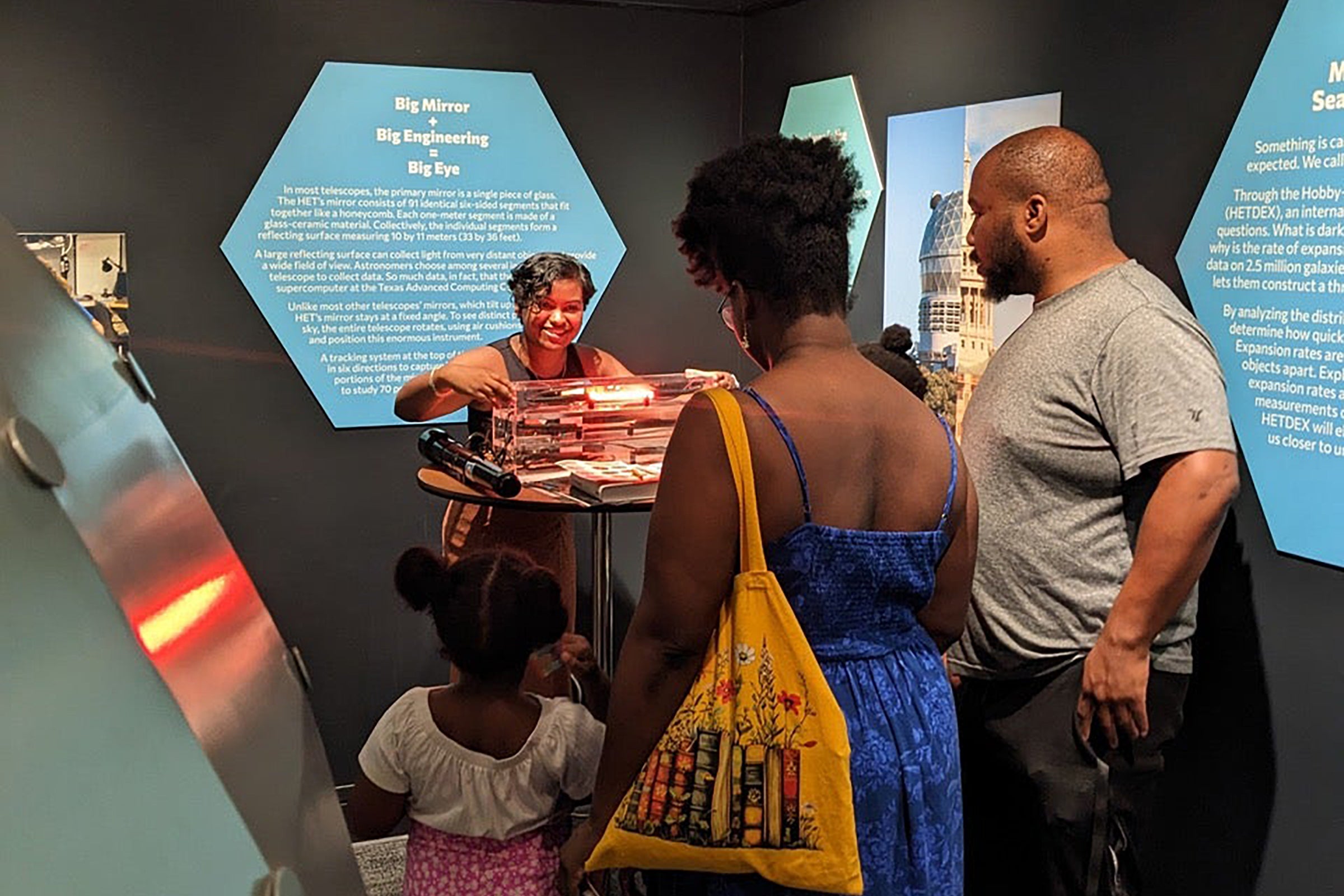 A family listens to an astronomy demo.