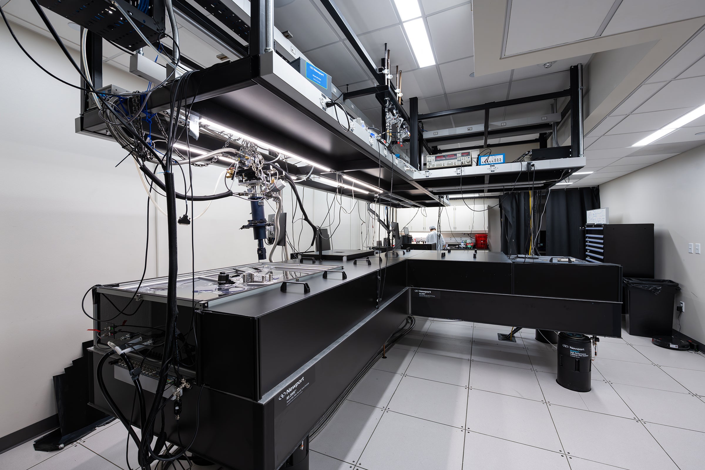 Large black table covered with scientific equipment in a white laboratory