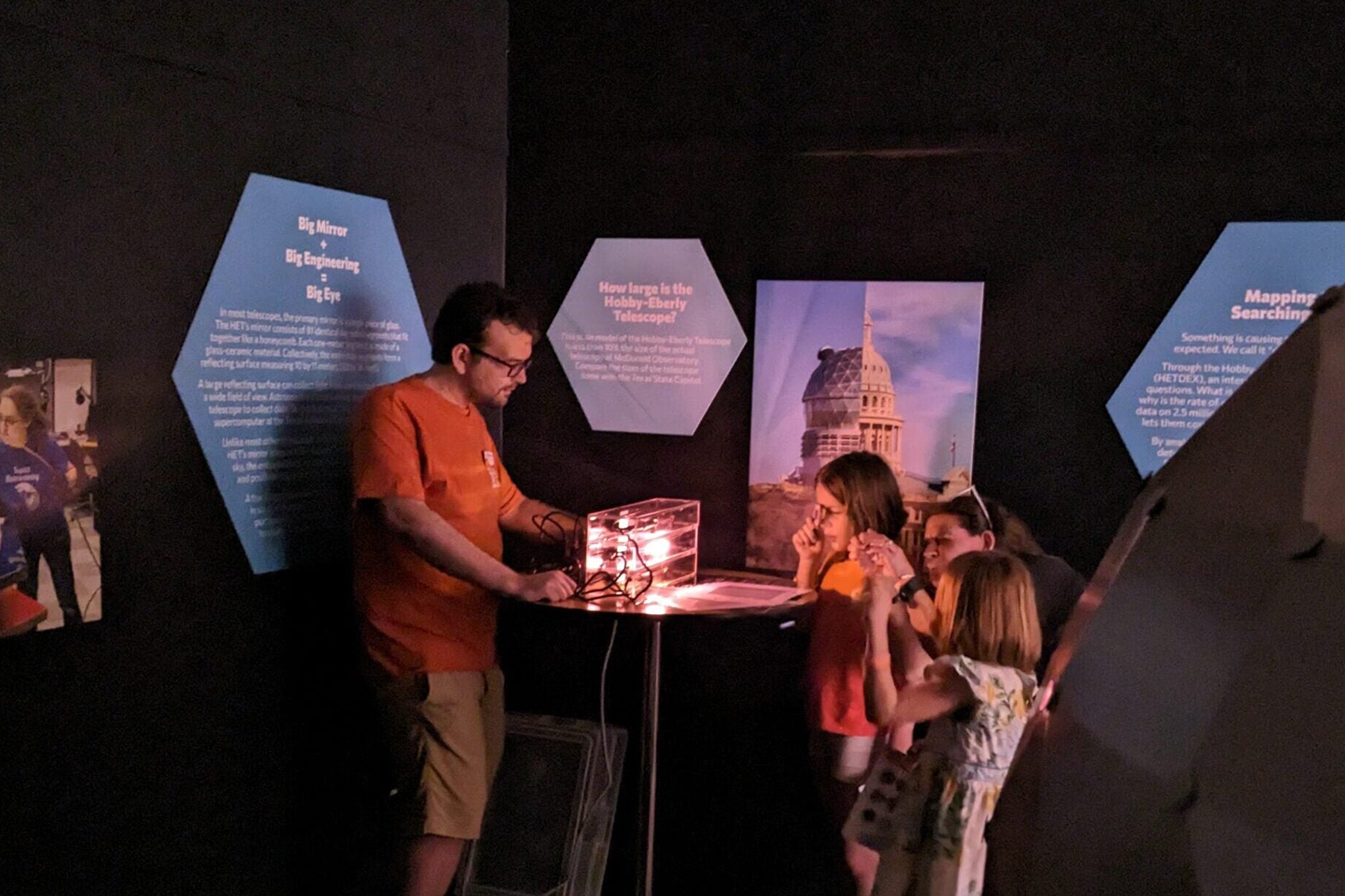 A man demonstrates refraction to a small group of children.