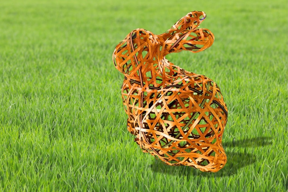 What looks like a basketwoven rabbit hovers over a field of grass