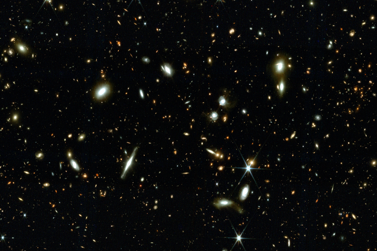 A deep view of space is dotted with stars and galaxies