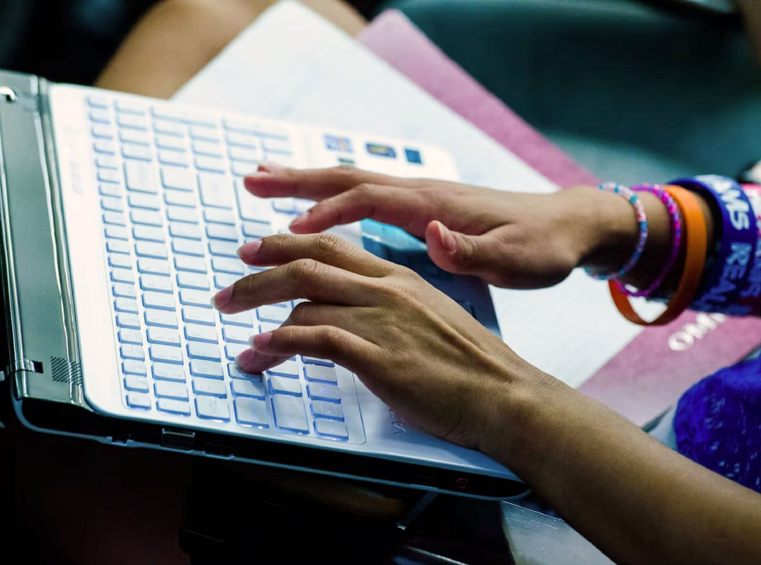 hands on laptop keyboard