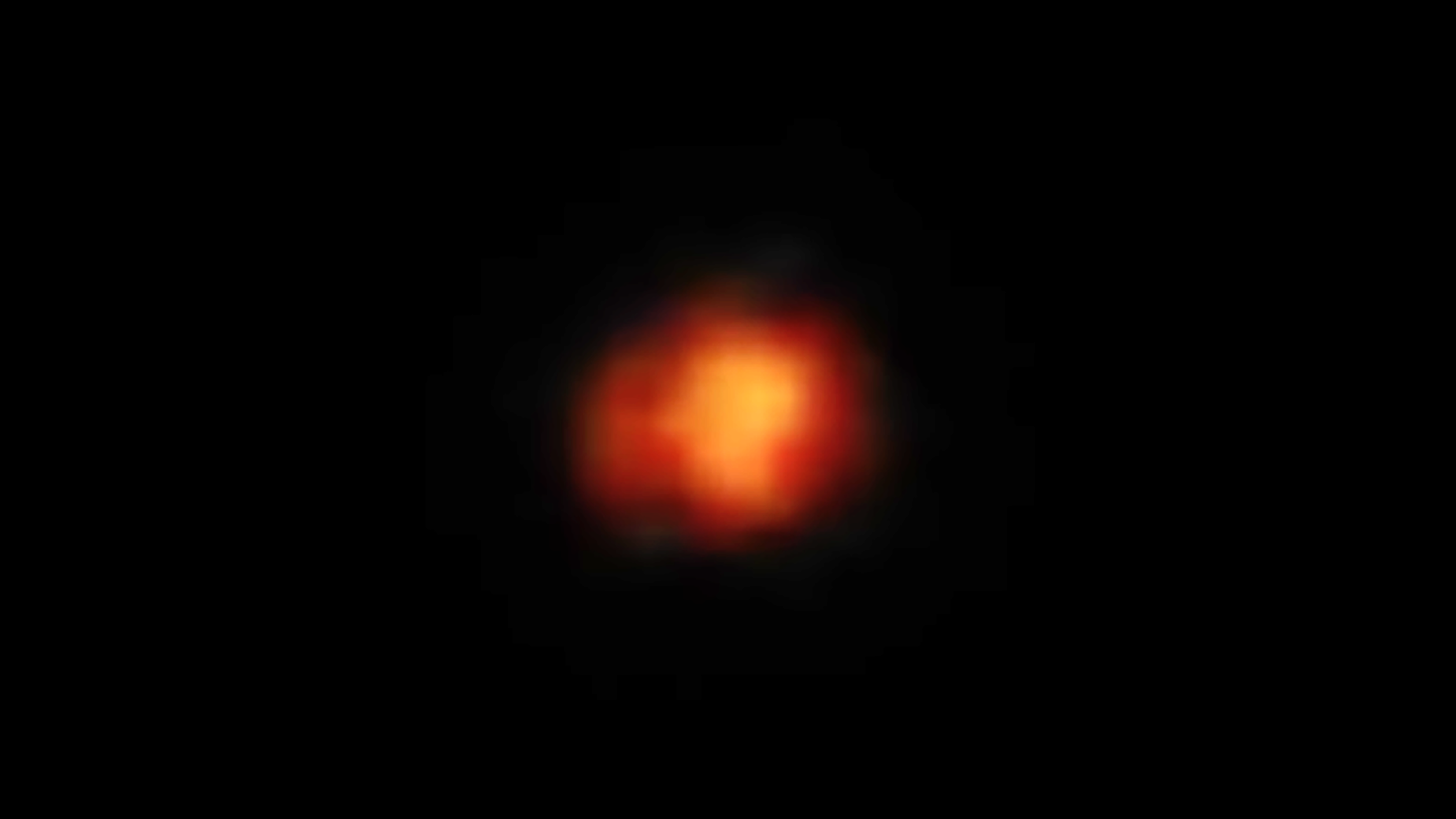 An orange-red blob in the center of a black background