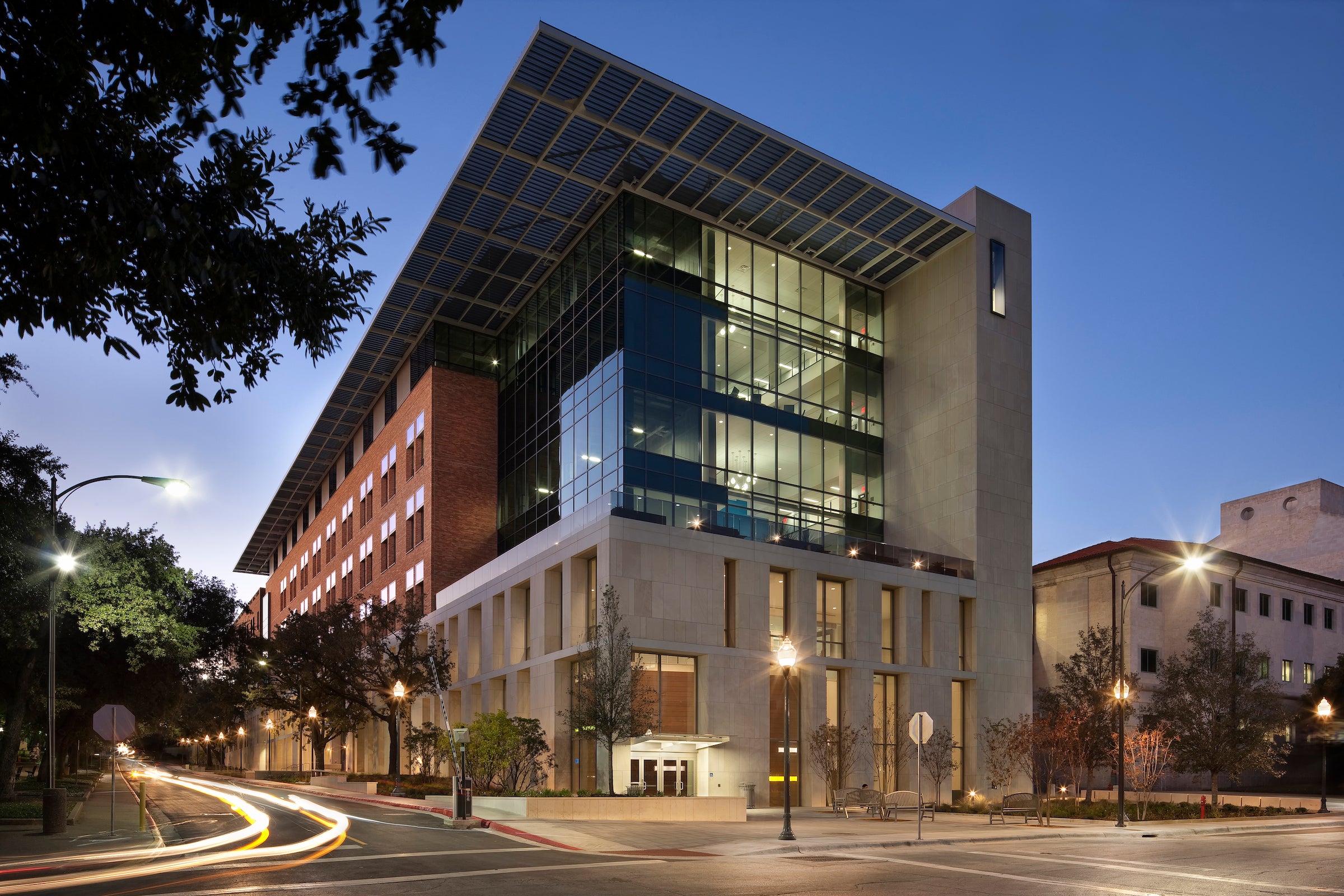 The Norman Hackerman Building shown at dusk with lights on