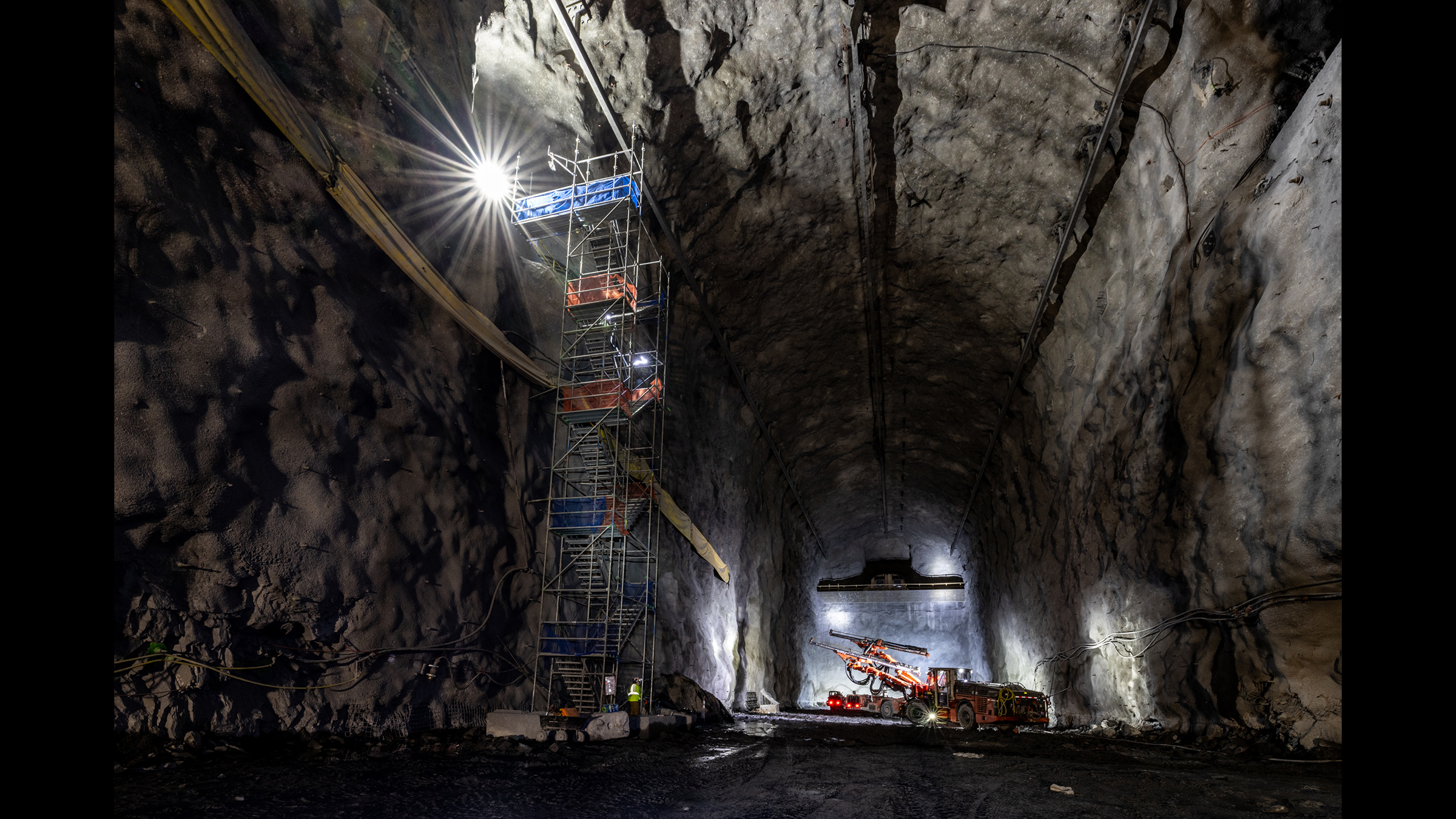 Cranes and other large equipment working in a large cavern