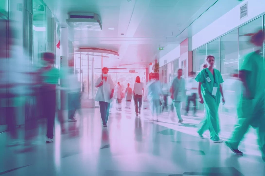 A blur of people and patients moving through a hospital hallway with effects that nod to technological influences