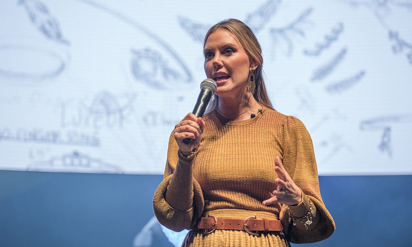 Photo of Kendra Scott holding a microphone