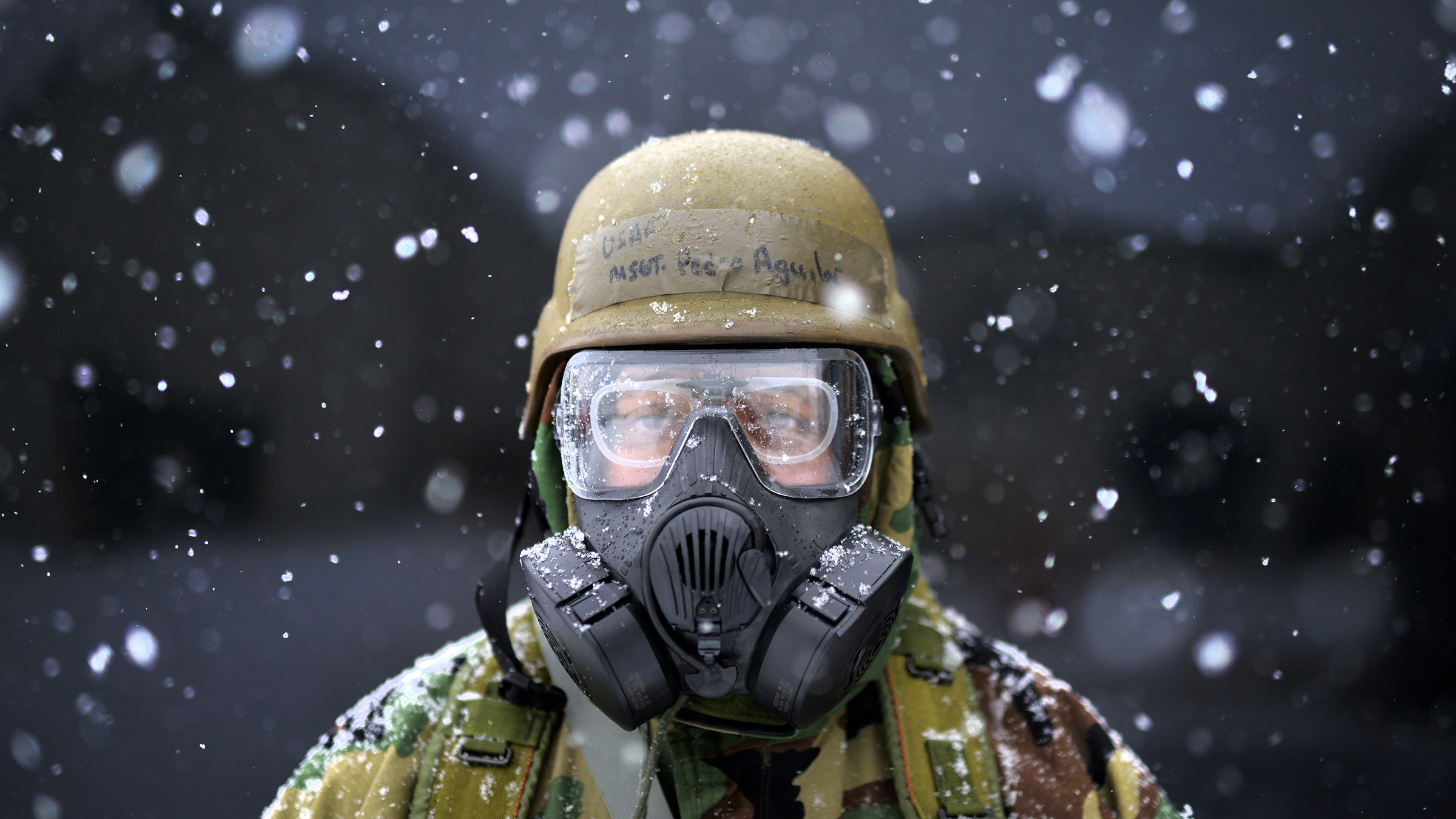 Soldier wearing uniform, helmet and gas mask