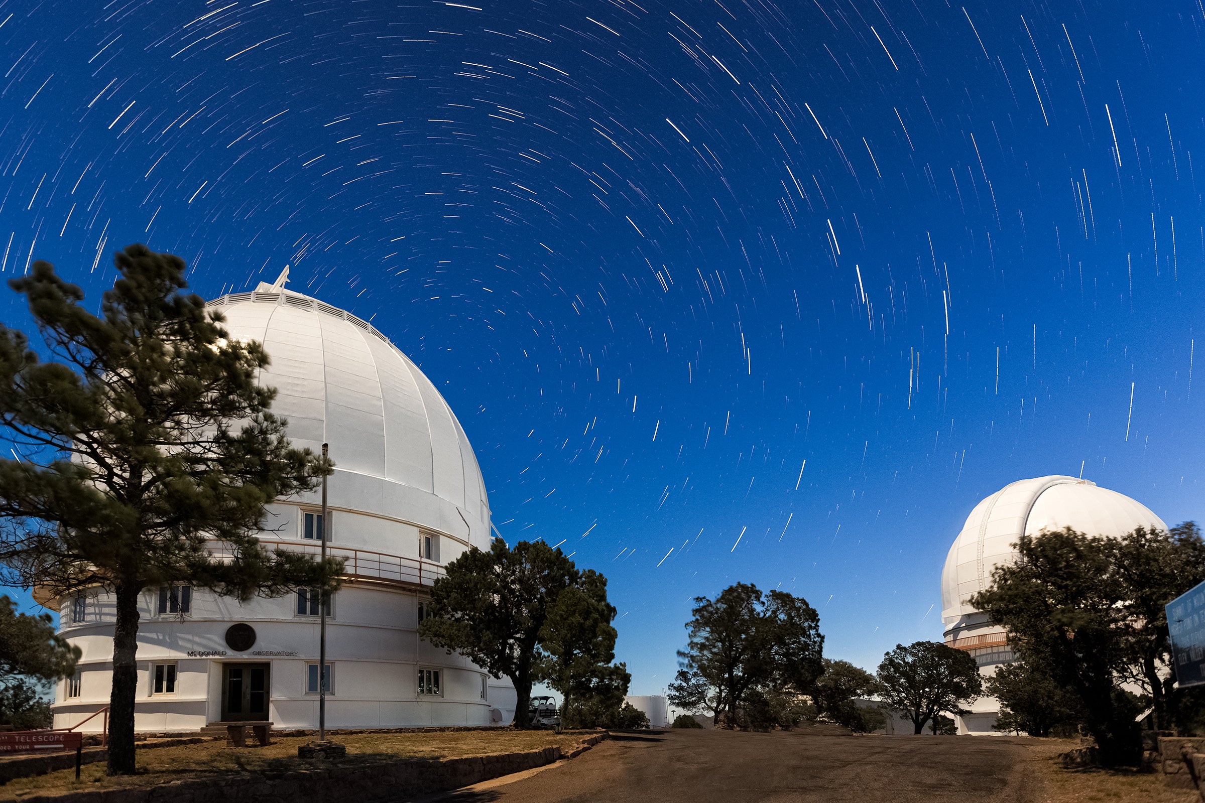 McDonald Observatory domes on Mt. Locke with star trails.