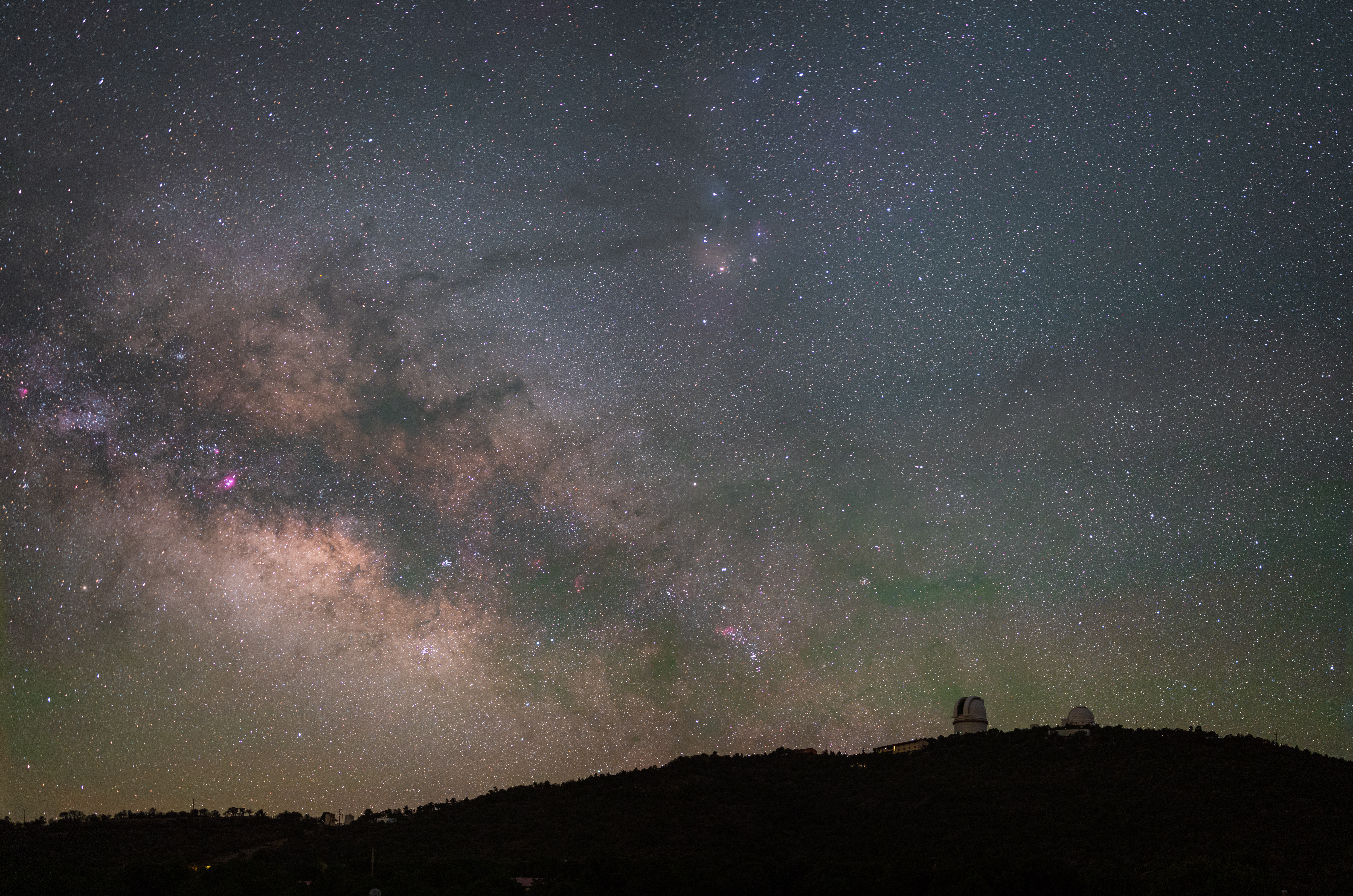 The Milky Way in the night sky is evident over a dark peak, Mt. Locke