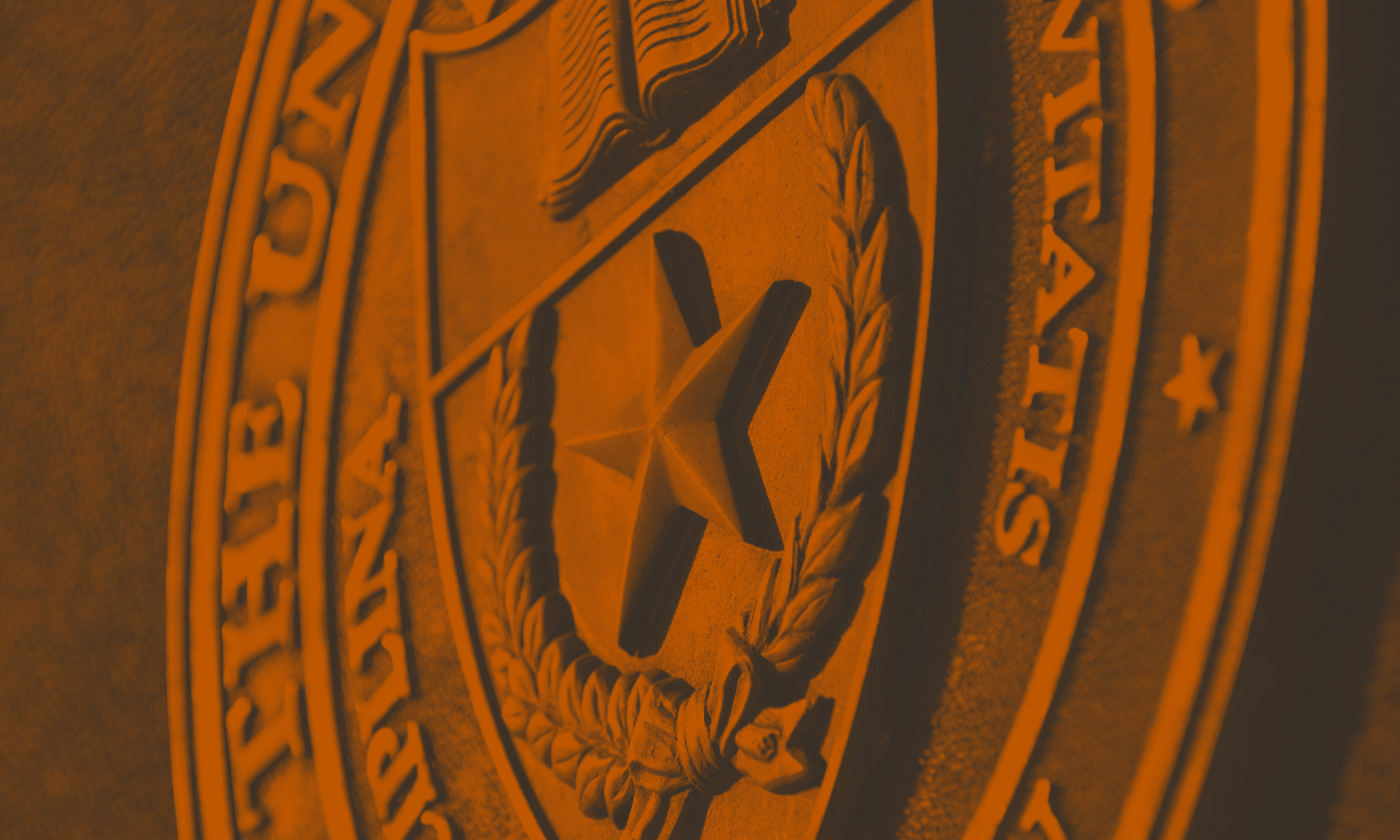 Seal of the university of texas with an orange filter