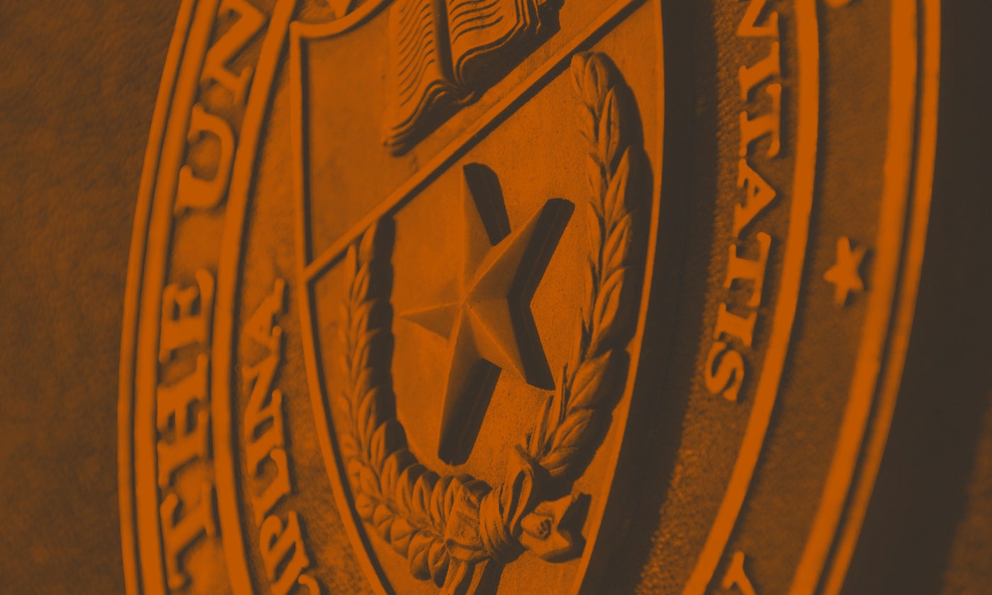 Seal of the university of texas with an orange filter