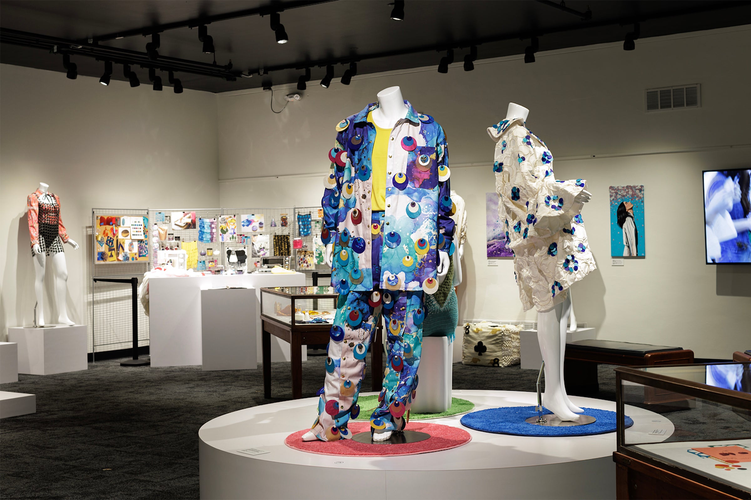 Two outfits on display at Particles of Color