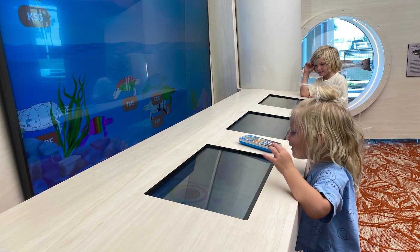 Two children interact with an exhibit in the newly renovated Patton Center