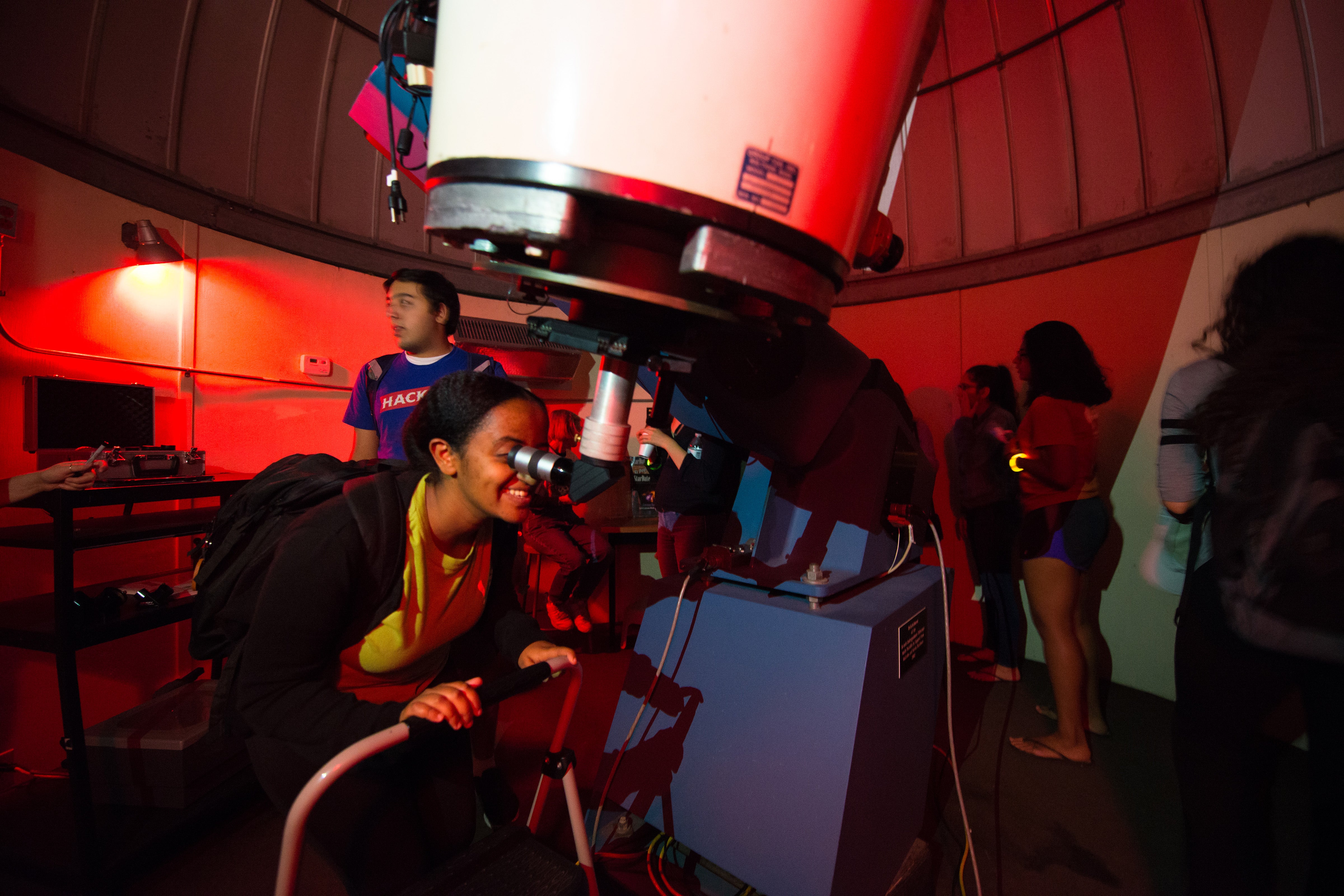 A woman looks through the telescope atop PMA at a star party in 2017.