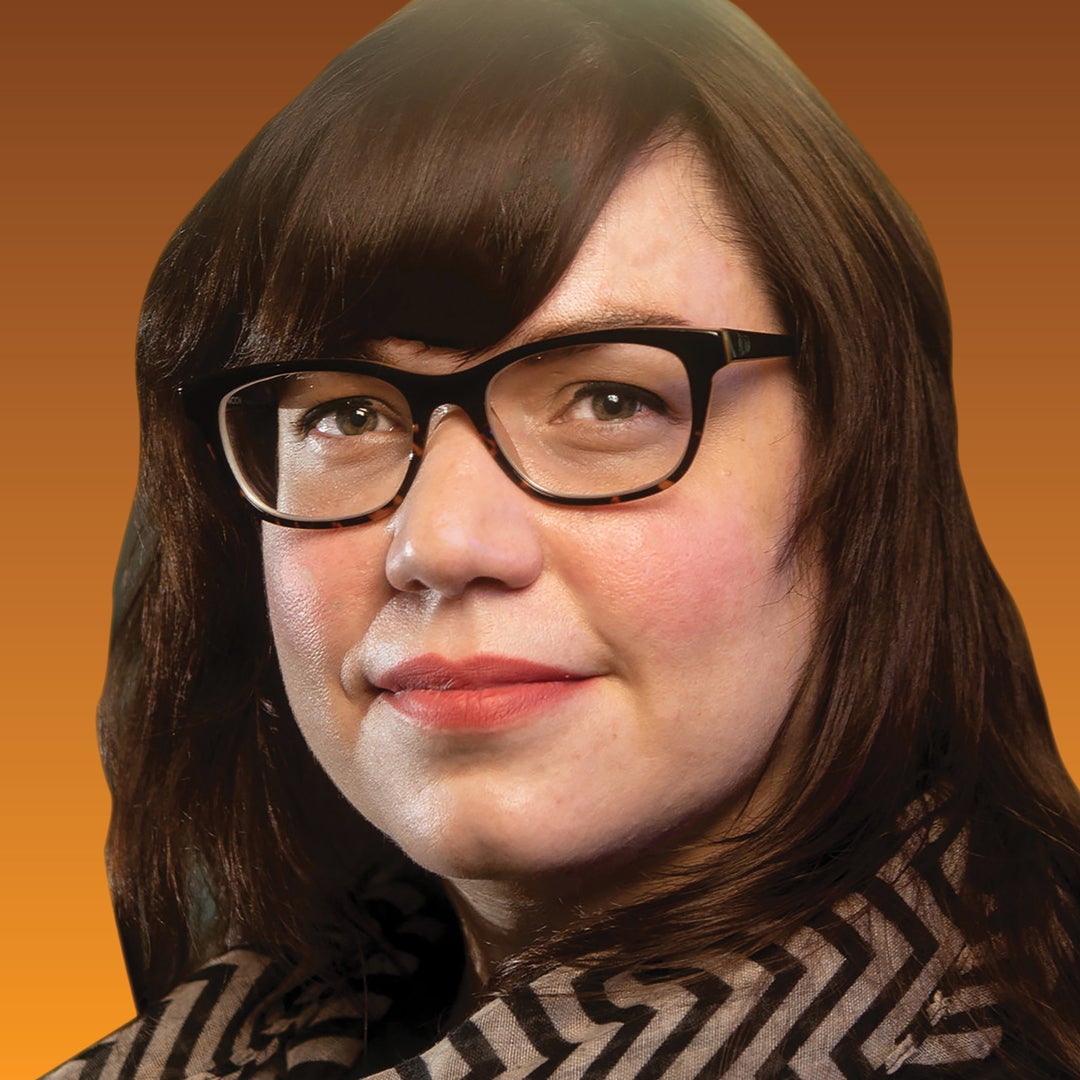 Head shot of a woman in glasses and a scarf
