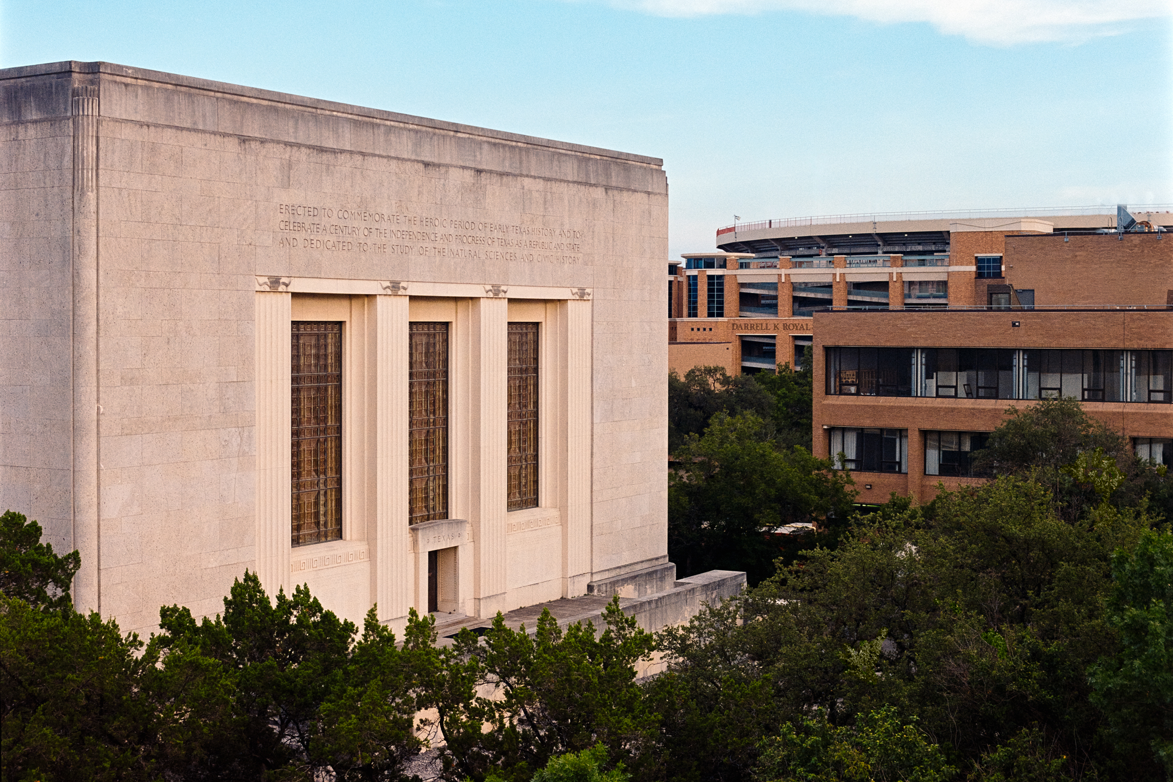 Photo of a limestone art deco building with three tall arched windows. Texas Memorial Museum. Texas Science and Natural History Museum.