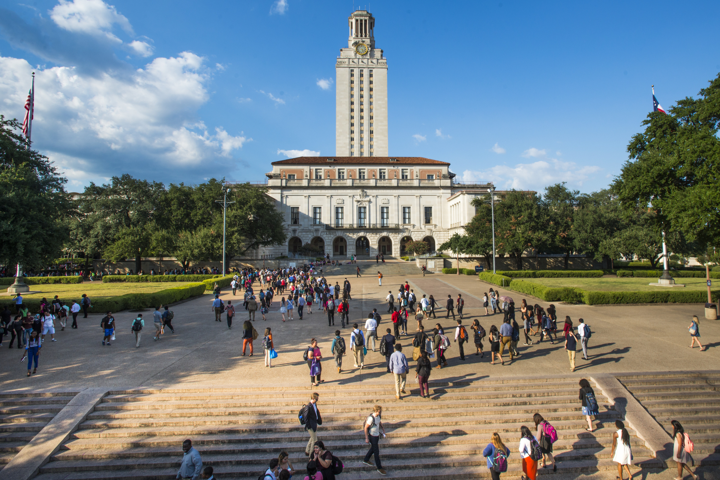 The UT Tower and Main Mall with its stairs are shown as students mill about on the University of Texas at Austin campus