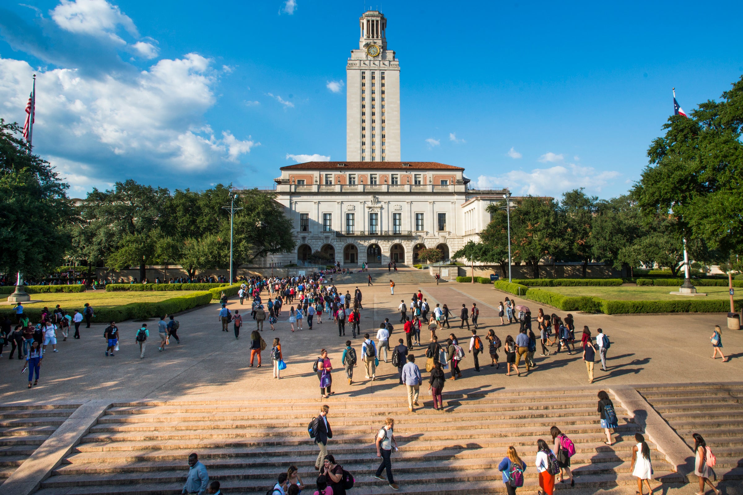 The UT Tower and Main Mall with its stairs are shown as students mill about on the University of Texas at Austin campus