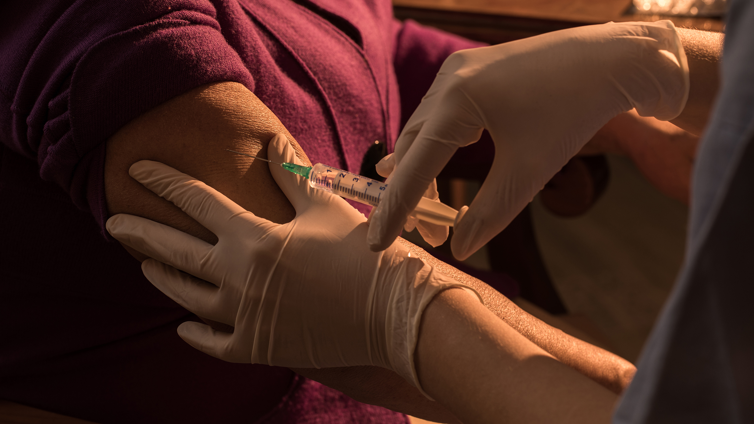 A patient receives a vaccination in the arm