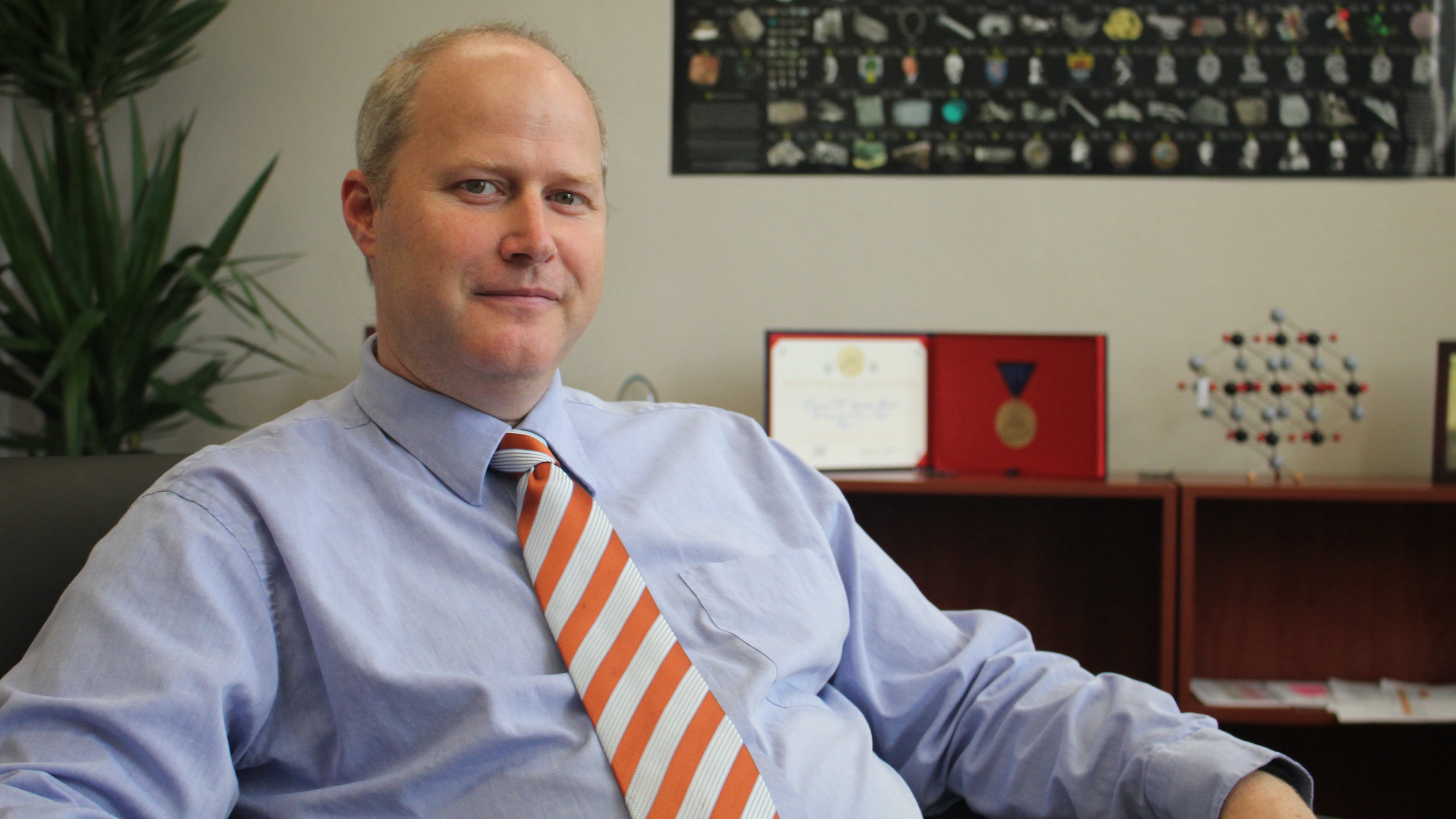 David Vanden Bout in tie in office in front of chemistry displays
