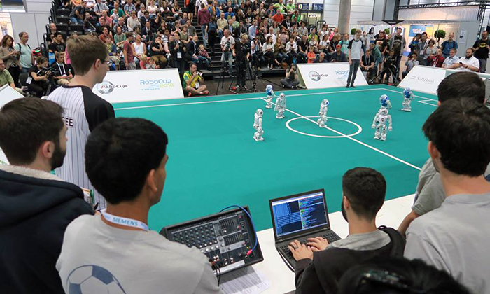 UT Austin Villa team members watch from the sidelines during a tight game with Nao-Team HTWK.