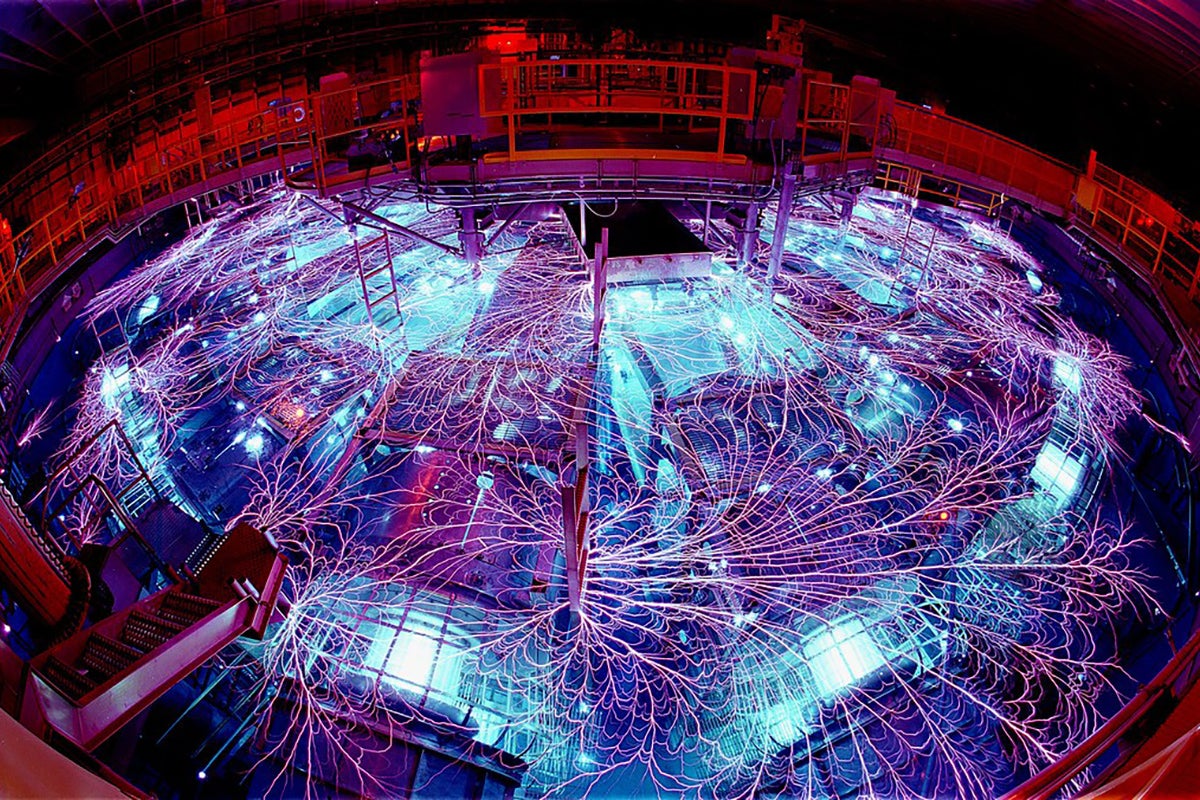 Room full of scientific equipment glowing blue and purple